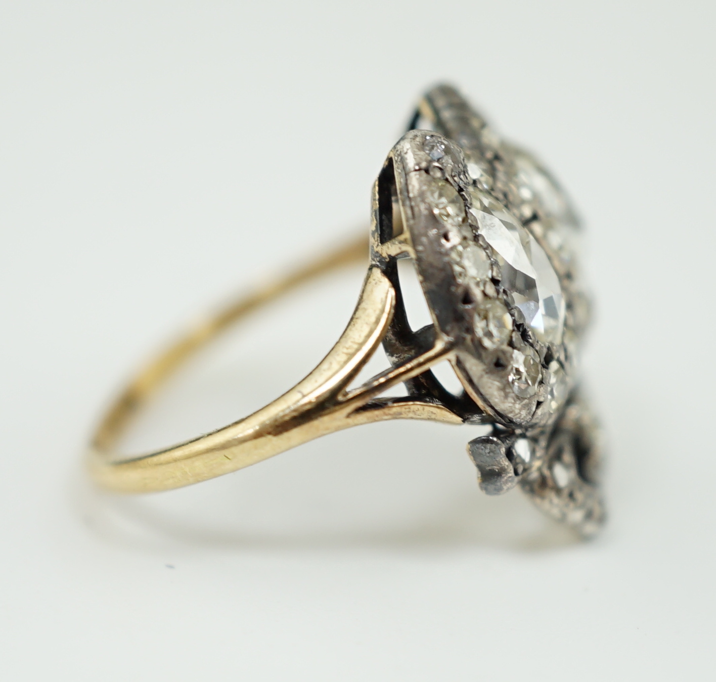 A 19th century gold, silver and diamond cluster set twin hearts ring, with ribbon bow surmounted